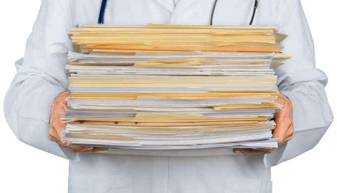 doctor with stack of files