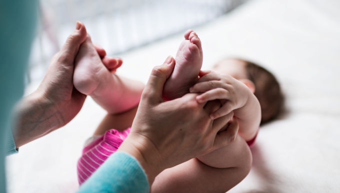Infant receiving chiropractic or osteopathic foot massage