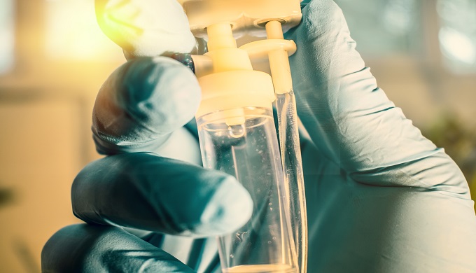 Doctor's gloved hand controlling perfusion offering cancer treatment