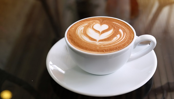 Hot latte coffee put on table in cafe restaurant.