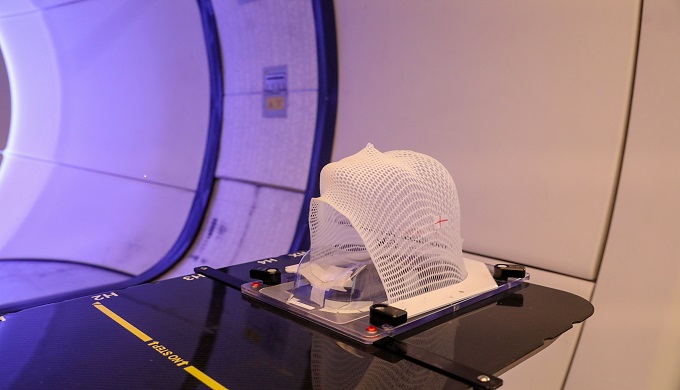 Patient Radiation proton therapy fixing mask showing laser lines for targeting cancer cells in the brain